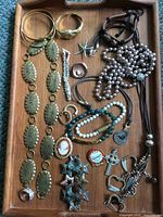 Full tray view of all 19 costume jewelry pieces