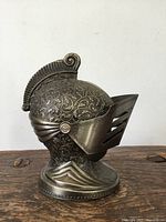 Left side view of knight helmet lighter showing embossing and visor detail