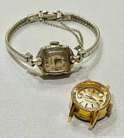 Front view of both watches showing dials and case designs