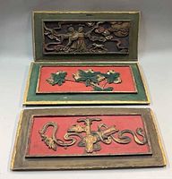 All three carved wood panels front view