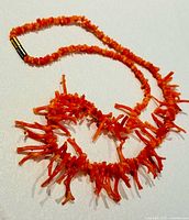 Full view of necklace laid flat showing overall design and clasp