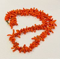 Full view of coral necklace coiled