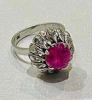 Ring angled showing pink cabochon and crown setting