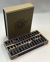 Abacus in front of closed presentation box