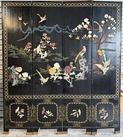 Front view of four-panel screen showing carved stone and painted landscape scene