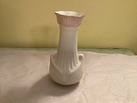 Front angled view of Belleek Moore vase showing fluted body and pink lustre rim