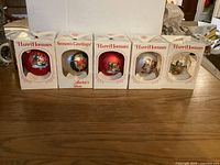 Five boxed ornaments lined up showing fronts and box text