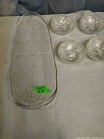 Close view of leaf-pattern tray and four small bowls