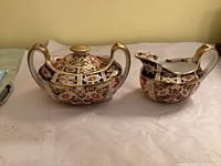 Creamer and lidded sugar bowl front view