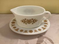 gravy boat with underplate showing Butterfly Gold pattern