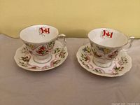 Two matching teacups and saucers displaying pattern