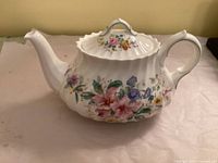 Left side of Royal Doulton Arcadia teapot showing floral pattern and shape