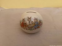 Front view showing Bunnykins family illustration and coin slot