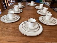 Full view of 8 five-piece place settings arranged on table