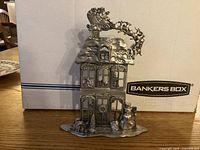 Front view showing Victorian house, Santa sleigh, snowman and trees