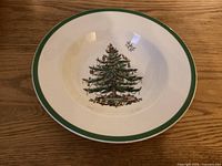 Front view of Spode Christmas Tree rimmed soup bowl showing green rim and tree graphic
