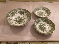 Top view of three green transferware bowls