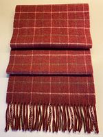 Full view of folded plaid cashmere scarf showing pattern and fringe