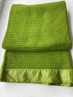 Blanket folded to show color, weave, satin trim