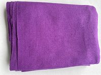 Folded fuchsia raw silk fabric showing thickness and color