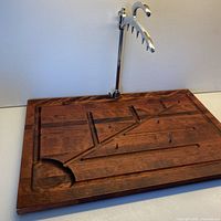 Full view of maple carving board with attached stainless arm