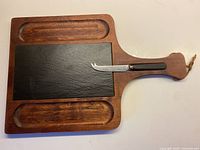 Cheeseboard showing slate insert, knife in slot, wood wells