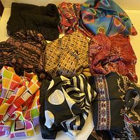 Group shot of all nine scarves showing colours, patterns and beadwork