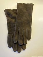 Pair of dark chocolate suede gloves front view
