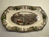 Full view of oval platter showing border and central Christmas scene