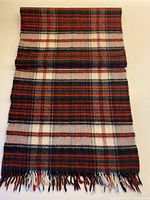 Full scarf laid flat showing tartan pattern and fringe