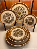 Front view of stacked Denby Langley plates showing floral pattern and sizes