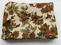 Folded floral linen fabric showing pattern and texture