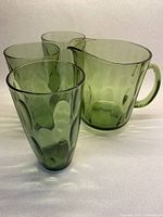 Pitcher and three green tumblers front view