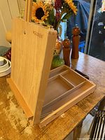 Side view of easel set up showing storage box and adjustable front lip