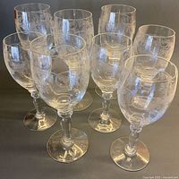 Full set of eight etched crystal wine glasses standing