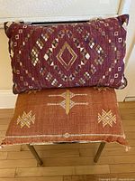 Front view of both pillows showing patterns and colours
