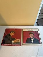 Both record sleeves side by side on table