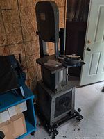 Full view of Craftex B227 bandsaw on mobile base with blade packages atop table