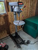 Full view of Craftsman floor drill press on rolling base