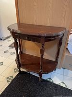 Full view of wooden demilune console table