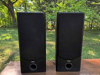 Front view of both Merak MT100 speakers with grilles on