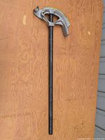 Full view of conduit bender showing cast head and handle