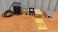 Front view of all components: Variac, power supply, Hammond chassis, fuse and paperwork