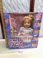 Front of factory-sealed My Real Baby doll box showing doll and accessories