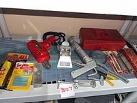 Shelf view with drill, toolbox, caulk gun, soldering iron holder, adhesives, misc. hardware