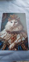 Full view of rectangular tin sign with cat in royal costume