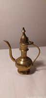 Full view upright brass ewer showing shape and engraved details