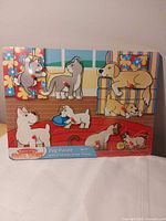 Front view of Melissa & Doug wooden peg puzzle with all six dog pieces in place