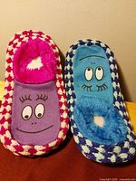 Front view of both pairs showing cartoon face fronts and checkerboard knit pattern