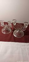 Both pressed glass double candle holders side by side